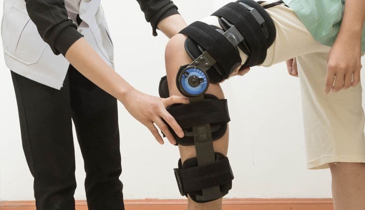 Physiotherapist supporting patient with real-life functional movement